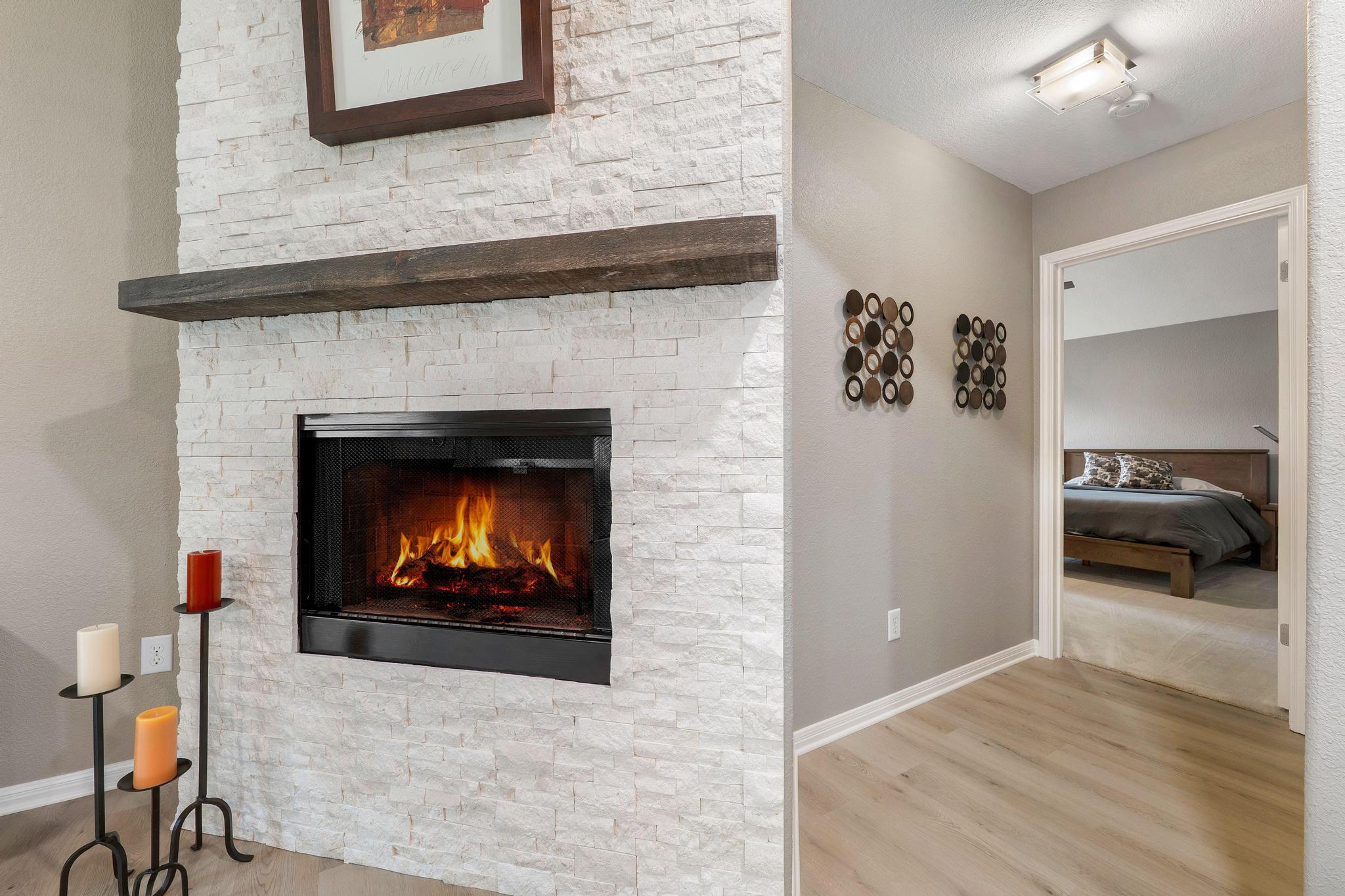 13231 Armaga Springs Road Austin, TX 78727 - Photo 21 of 36 Detailed view of a stone fireplace and wood finished floors