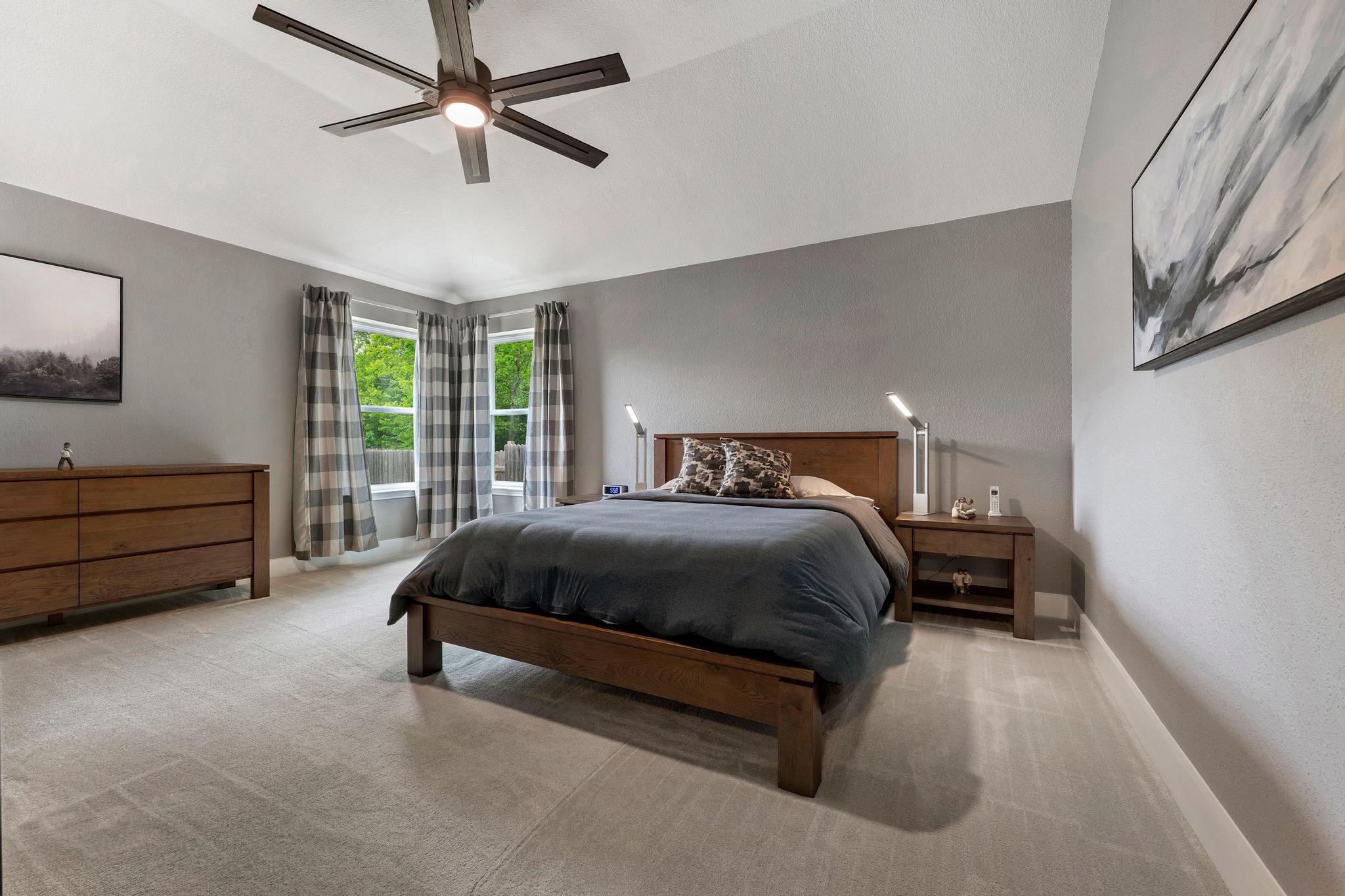 13231 Armaga Springs Road Austin, TX 78727 - Photo 22 of 36 Bedroom with light carpet, lofted ceiling, and a ceiling fan