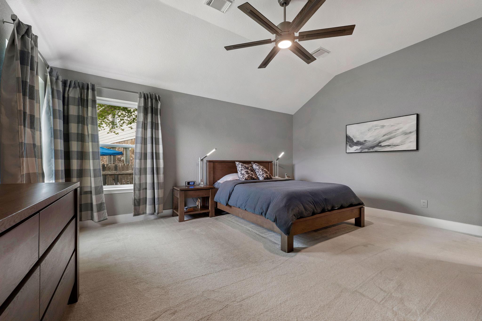 13231 Armaga Springs Road Austin, TX 78727 - Photo 23 of 36 Bedroom with light carpet, a ceiling fan, and vaulted ceiling