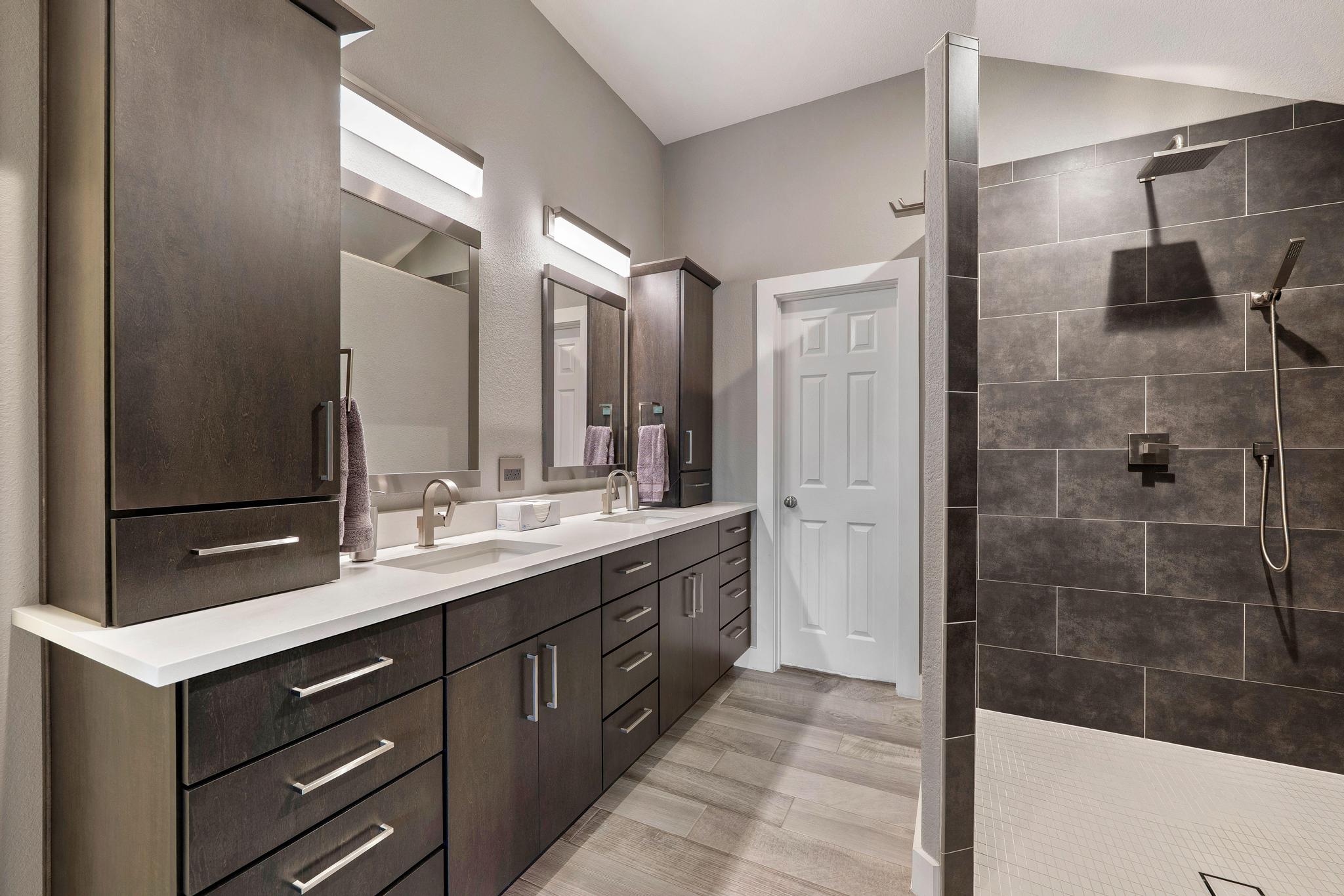 13231 Armaga Springs Road Austin, TX 78727 - Photo 25 of 36 Bathroom with double vanity, walk in shower, and light wood finished floors