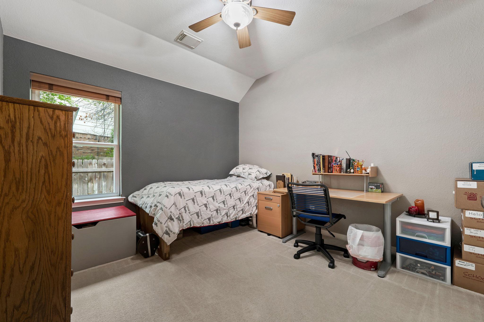13231 Armaga Springs Road Austin, TX 78727 - Photo 28 of 36 Bedroom featuring lofted ceiling, an office area, light colored carpet, and a ceiling fan