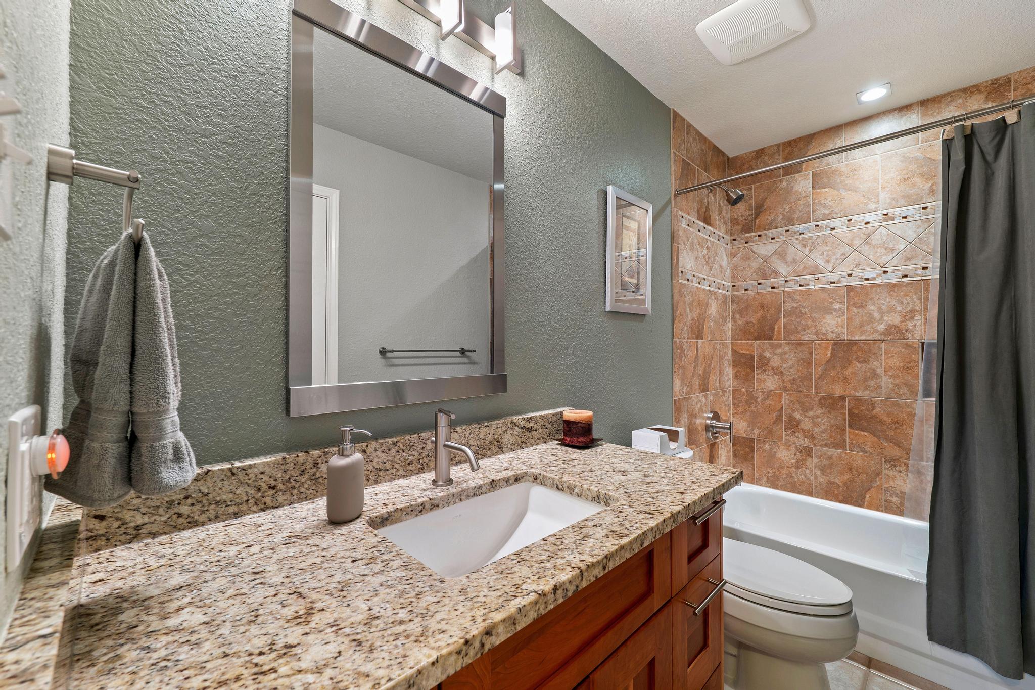 13231 Armaga Springs Road Austin, TX 78727 - Photo 30 of 36 Full bathroom with a textured wall, vanity, and shower / tub combo with curtain
