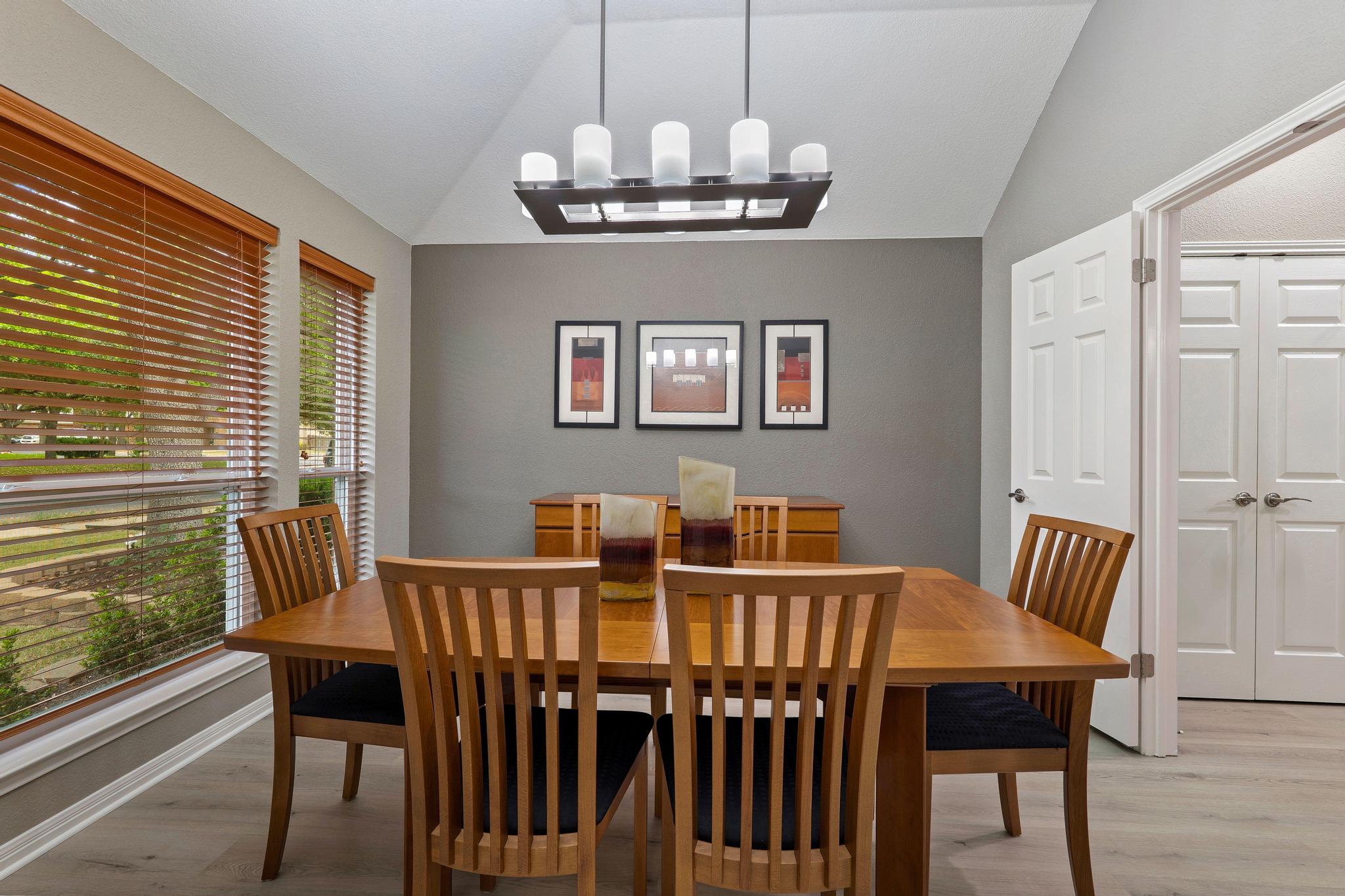 13231 Armaga Springs Road Austin, TX 78727 - Photo 8 of 36 Dining room with vaulted ceiling, light wood finished floors, and suspended lighting