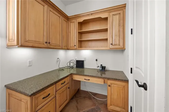 a kitchen with granite countertop a sink and cabinets