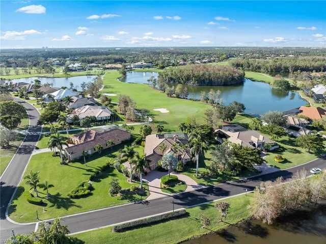an aerial view of lake and residential houses with outdoor space
