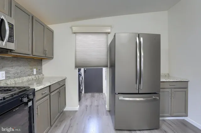 a kitchen with a refrigerator sink and stove