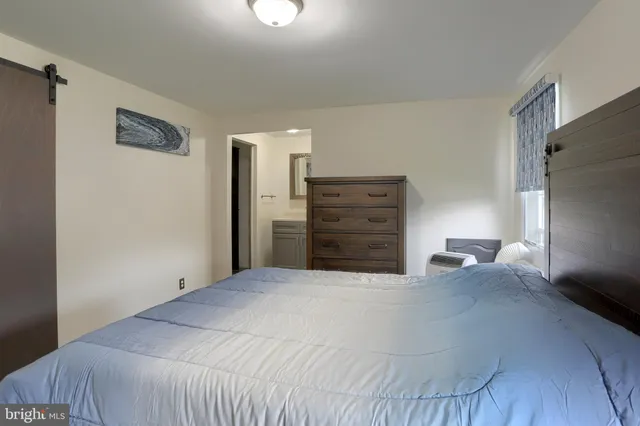 a bedroom with a bed and cabinet