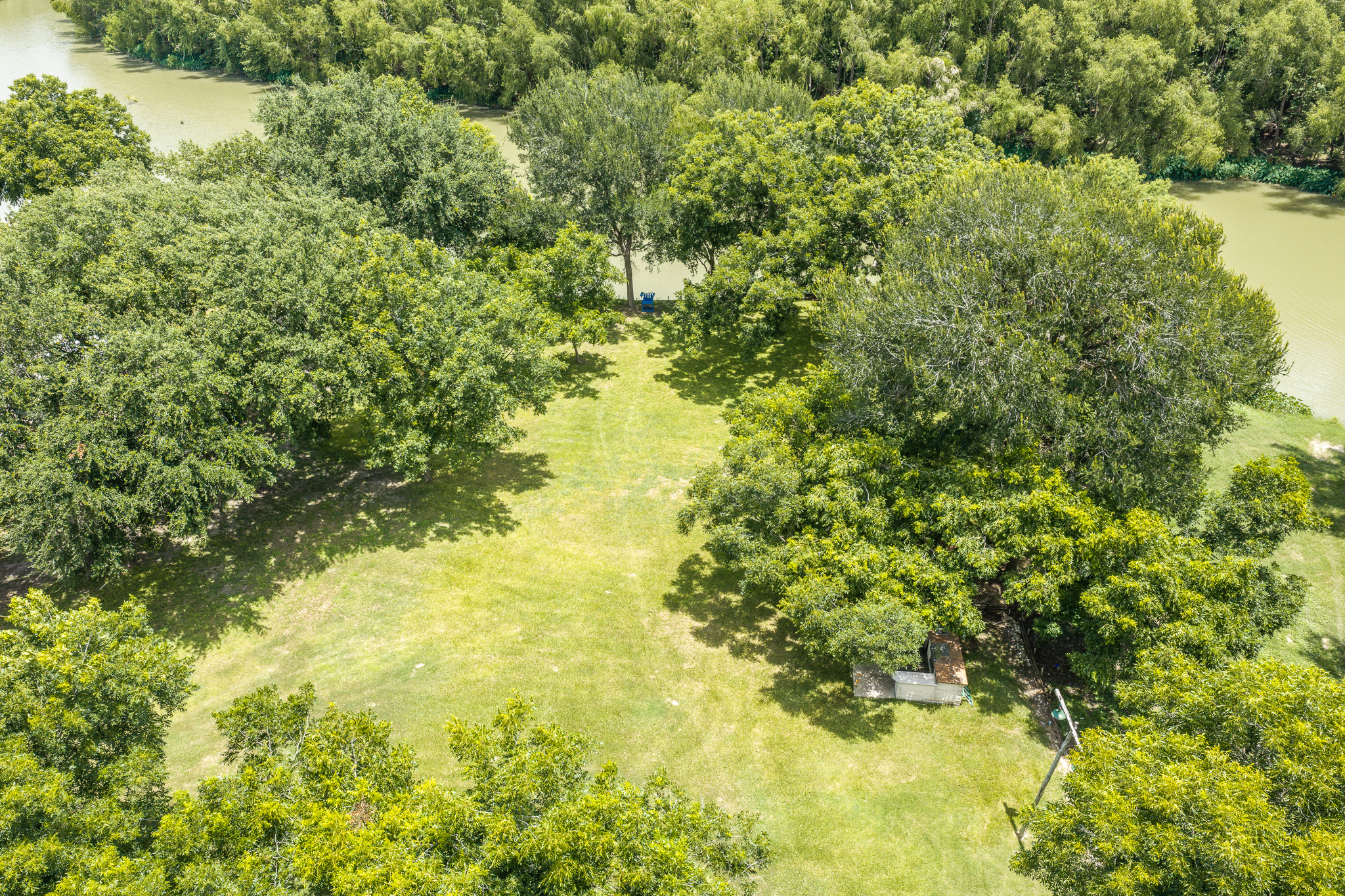 Tbd Goodwin Road Gonzales, TX 78629 - Photo 24 of 33 A verdant parcel bordering a tranquil waterway, offering ample space for outdoor pursuits.