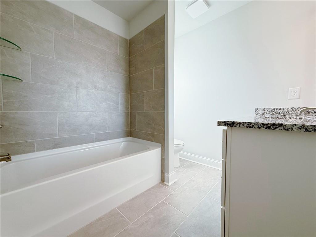 1450 Sunny Valley Lane Braselton, GA 30517 - Photo 18 of 24 a bathroom with a bathtub and a shower