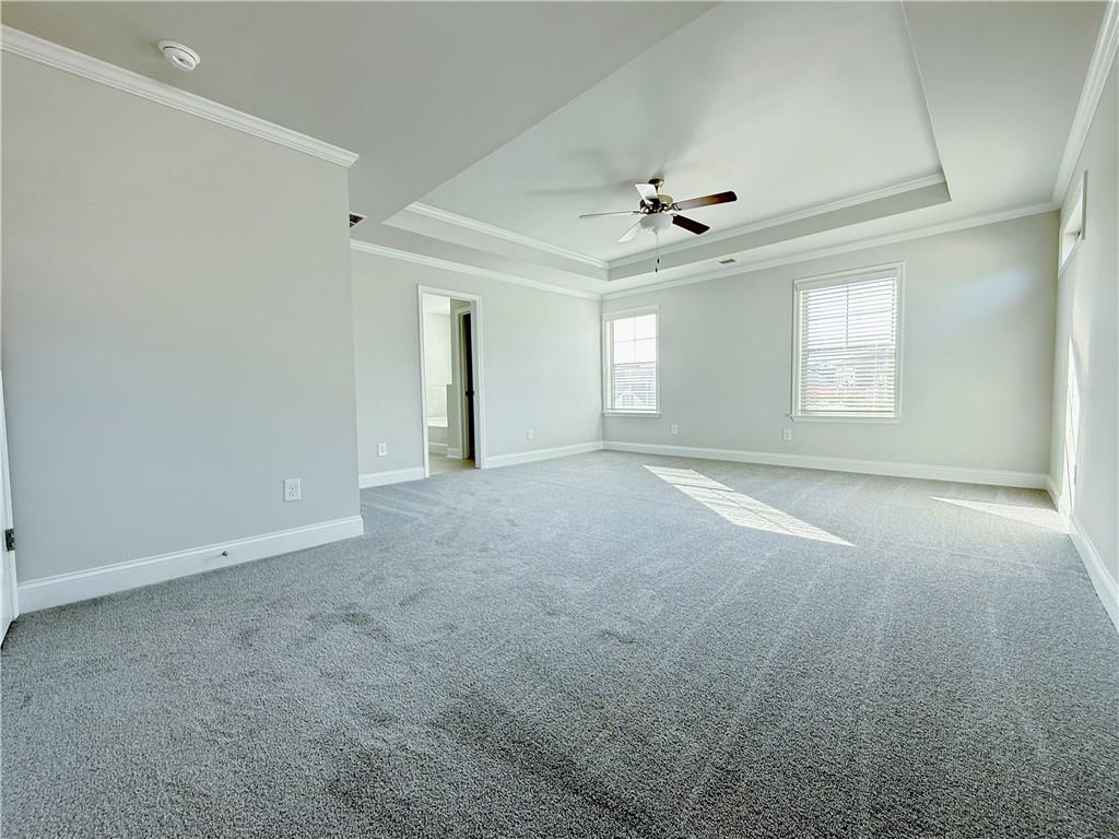 1450 Sunny Valley Lane Braselton, GA 30517 - Photo 10 of 24 an empty room with windows and ceiling fan