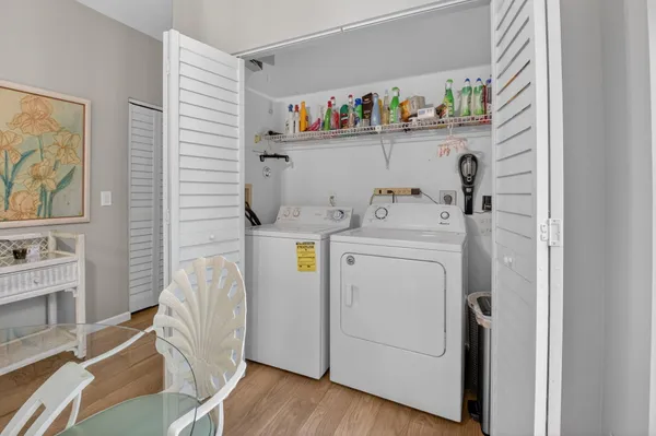 a utility room with dryer washer and a fridge