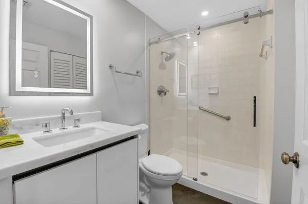 a bathroom with a sink toilet and shower