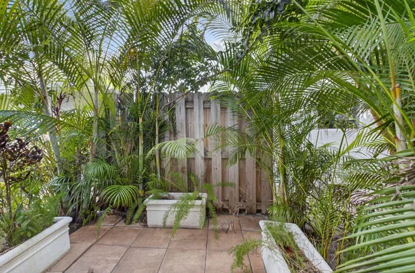 a backyard of a house with outdoor seating