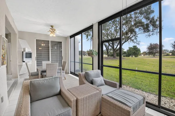 a living room with furniture and a floor to ceiling window