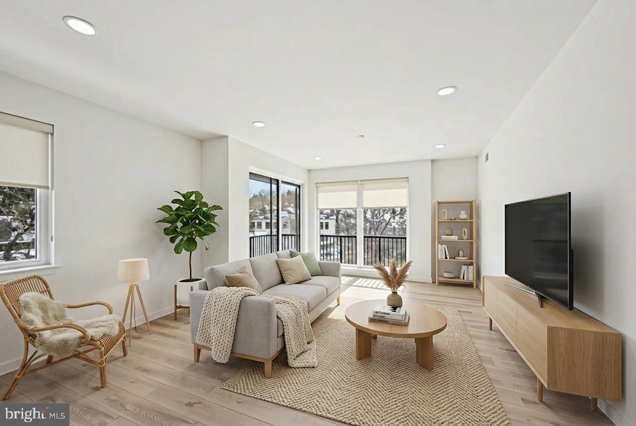 23 Rock Hill Road, Unit 514 Bala Cynwyd, PA 19004 - Photo 2 of 7 a living room with furniture and a flat screen tv