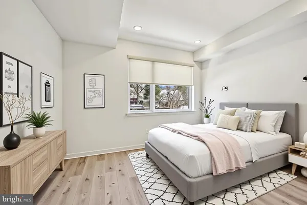 a bedroom with a large bed and a window
