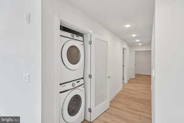 a view of a hallway with washer and dryer