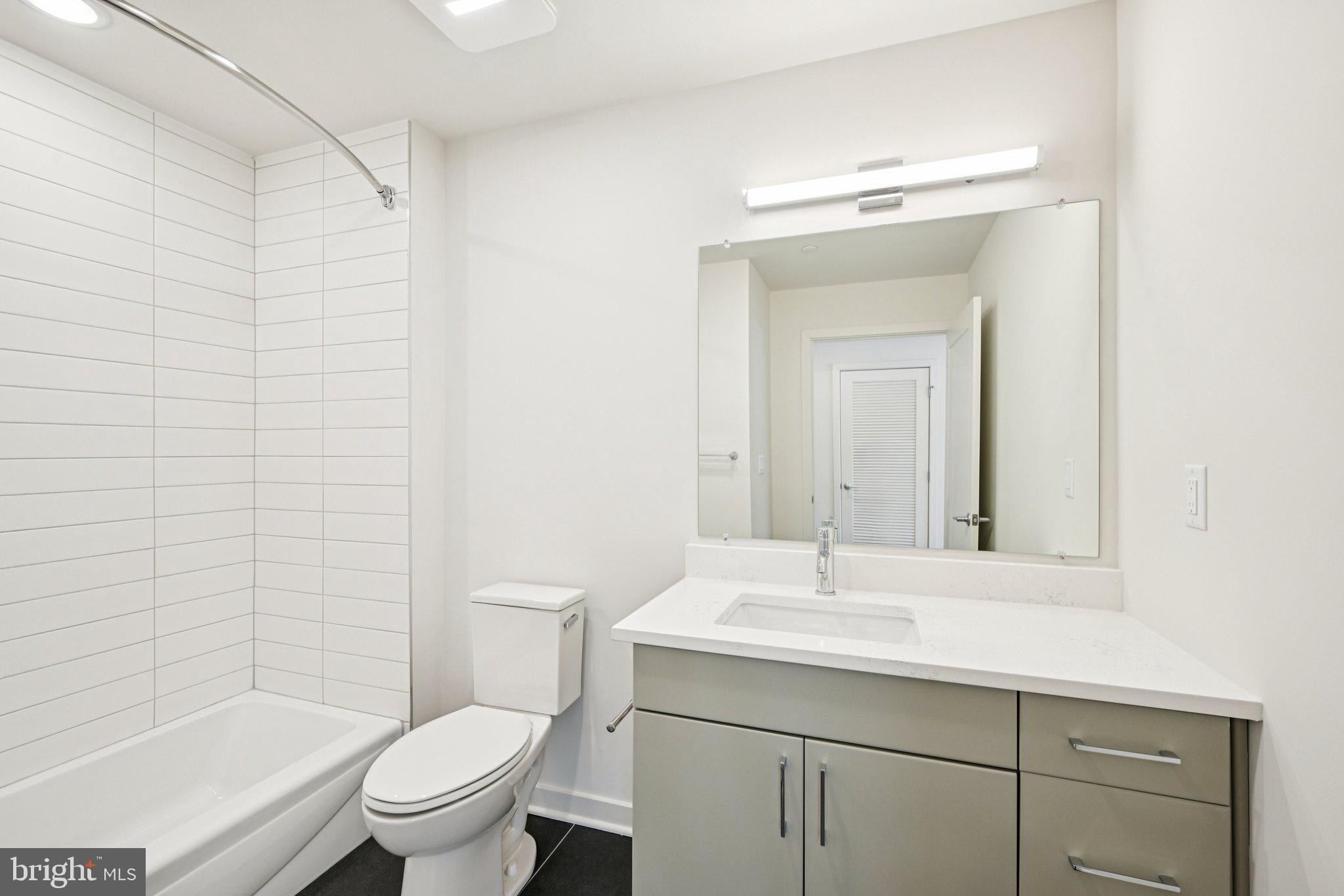 23 Rock Hill Road, Unit 514 Bala Cynwyd, PA 19004 - Photo 6 of 7 a bathroom with a sink a toilet and shower