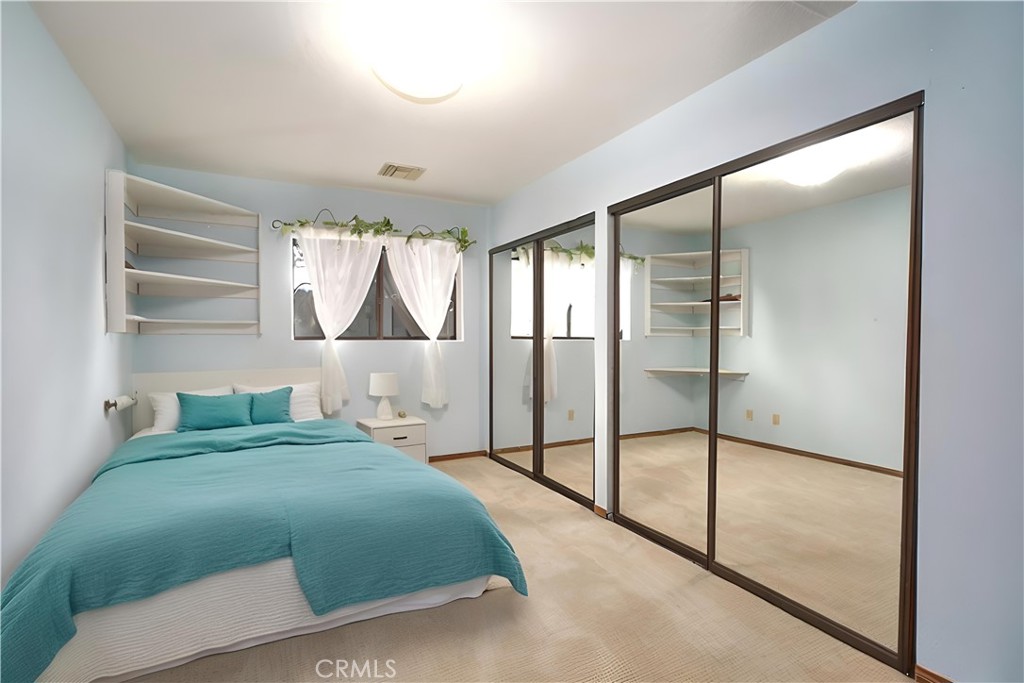 23109 Cardinal Road Wrightwood, CA 92397 - Photo 17 of 49 a bedroom with a bed and a window