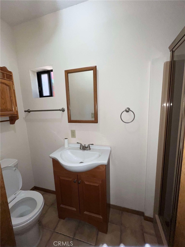 23109 Cardinal Road Wrightwood, CA 92397 - Photo 8 of 49 a bathroom with a toilet a sink and mirror