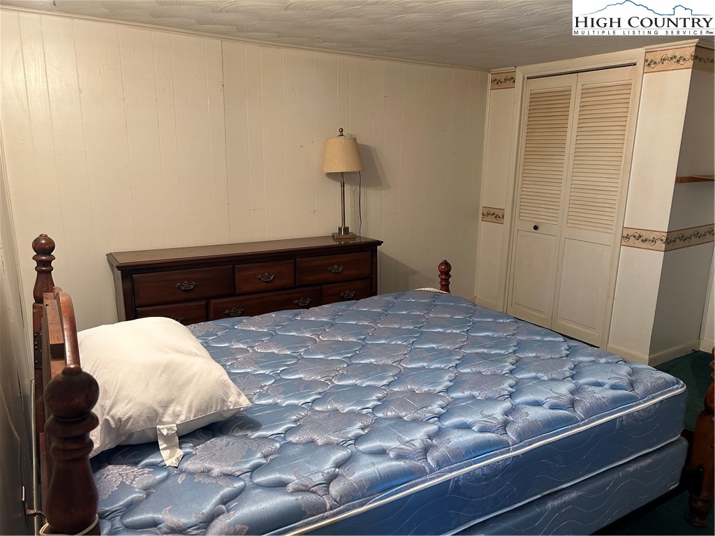 294 Walter Blevins Road Lansing, NC 28643 - Photo 14 of 15 a bedroom with a bed and a dresser