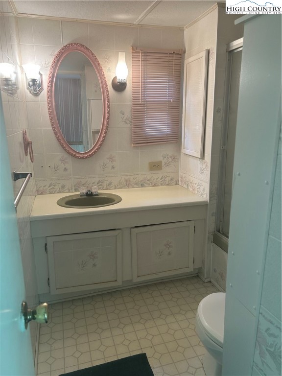 294 Walter Blevins Road Lansing, NC 28643 - Photo 5 of 15 a bathroom with a sink a toilet and a mirror