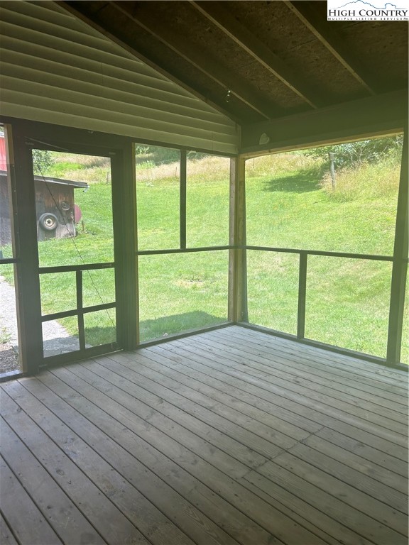 294 Walter Blevins Road Lansing, NC 28643 - Photo 8 of 15 a view of an empty room with a window and wooden floor