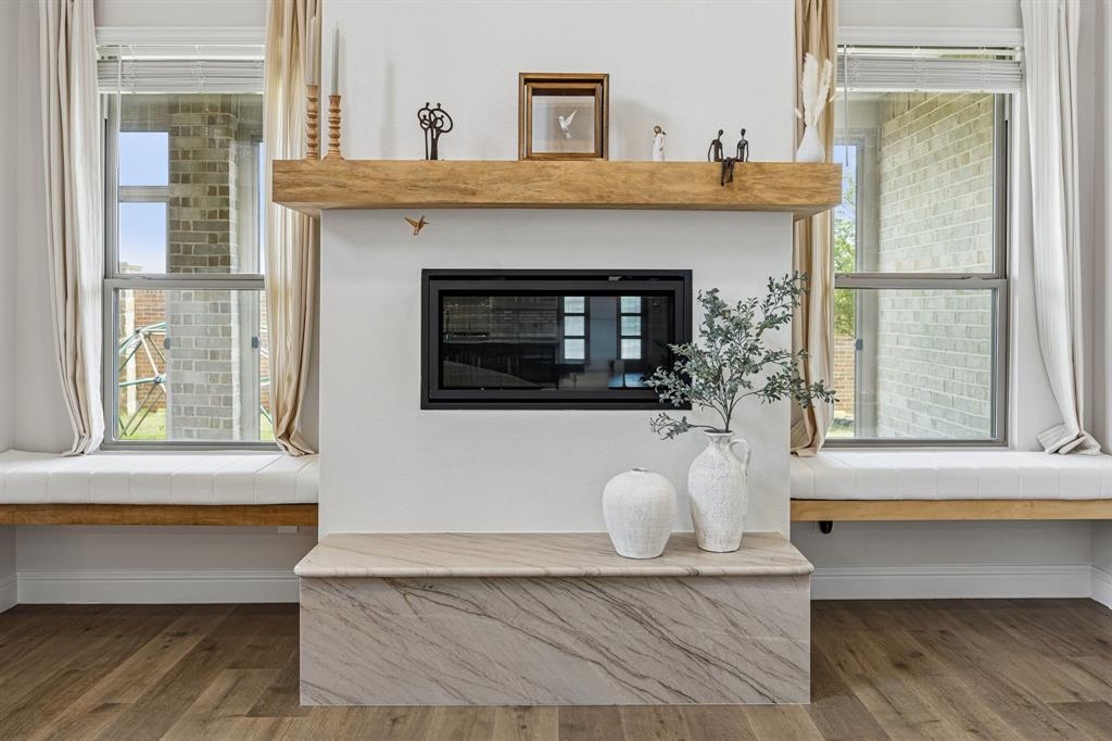 425 Breeds Hl Road Little Elm, TX 75068 - Photo 10 of 38 a living room with a fireplace and windows