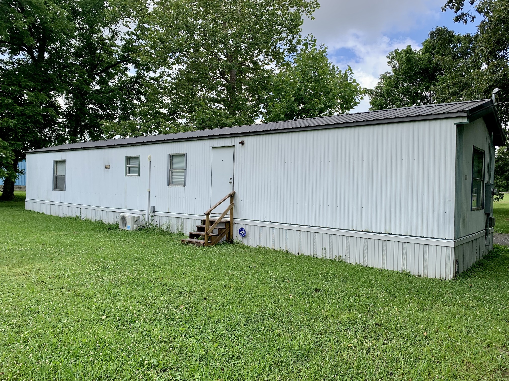 a view of a backyard with a garden and cabin