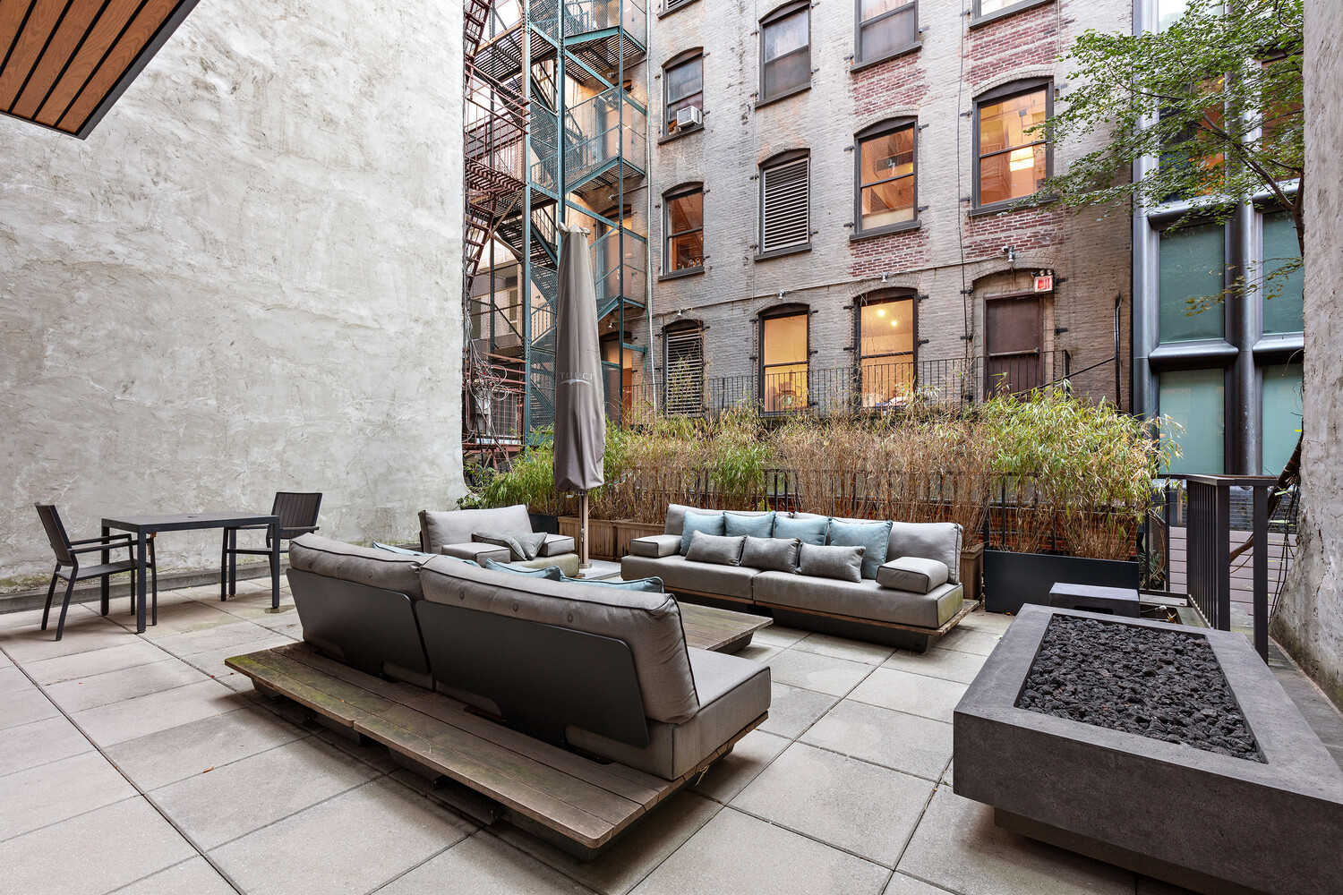 45 Great Jones Street, Unit 2 Manhattan, NY 10012 - Photo 10 of 11 a view of a patio with couches and potted plants