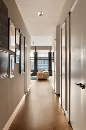 a large white kitchen with kitchen island a sink stainless steel appliances and cabinets
