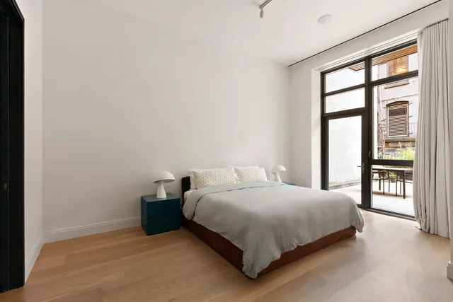 a view of a hallway with glass door and chandelier