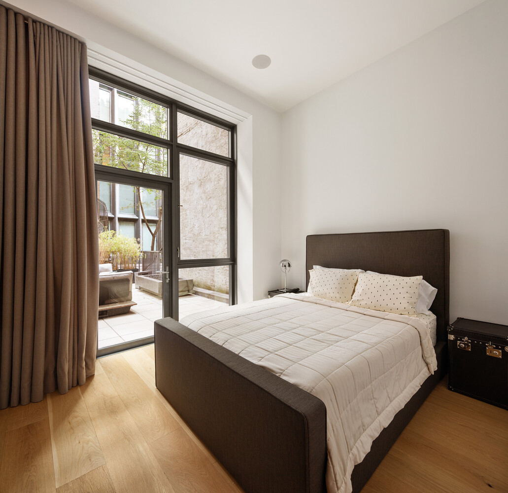 45 Great Jones Street, Unit 2 Manhattan, NY 10012 - Photo 7 of 11 a large bedroom with a large bed and a large window