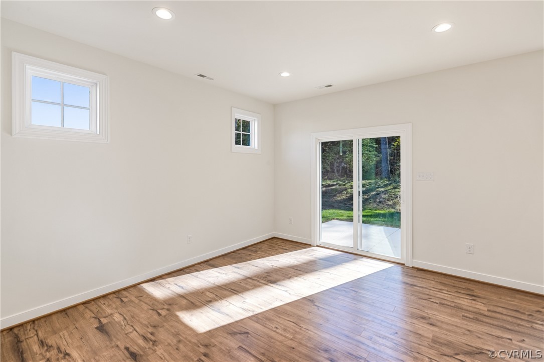 1706 Mainsail Lane Chester, VA 23836 - Photo 11 of 28 a view of an empty room with wooden floor and a window