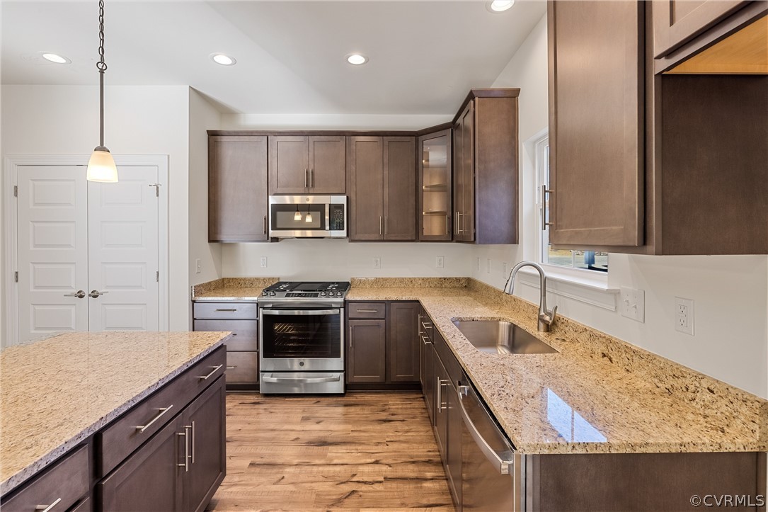 1706 Mainsail Lane Chester, VA 23836 - Photo 6 of 28 a kitchen with stainless steel appliances granite countertop a sink and stove top oven with wooden floor