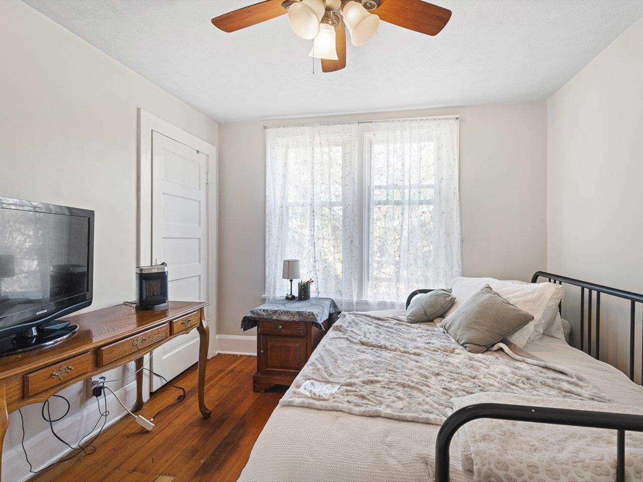 239 South Walnut Street Stillman Valley, IL 61084 - Photo 19 of 42 a bedroom with furniture and a flat screen tv