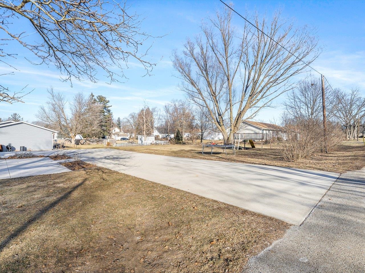 239 South Walnut Street Stillman Valley, IL 61084 - Photo 36 of 42 a view of road with large trees