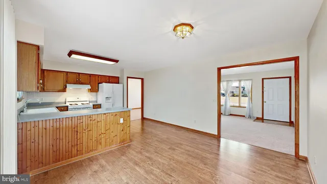 a kitchen with granite countertop a sink cabinets and stove