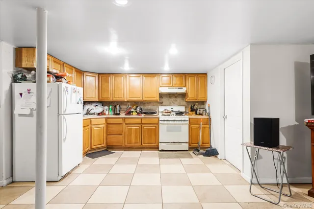 a kitchen with a refrigerator and cabinets