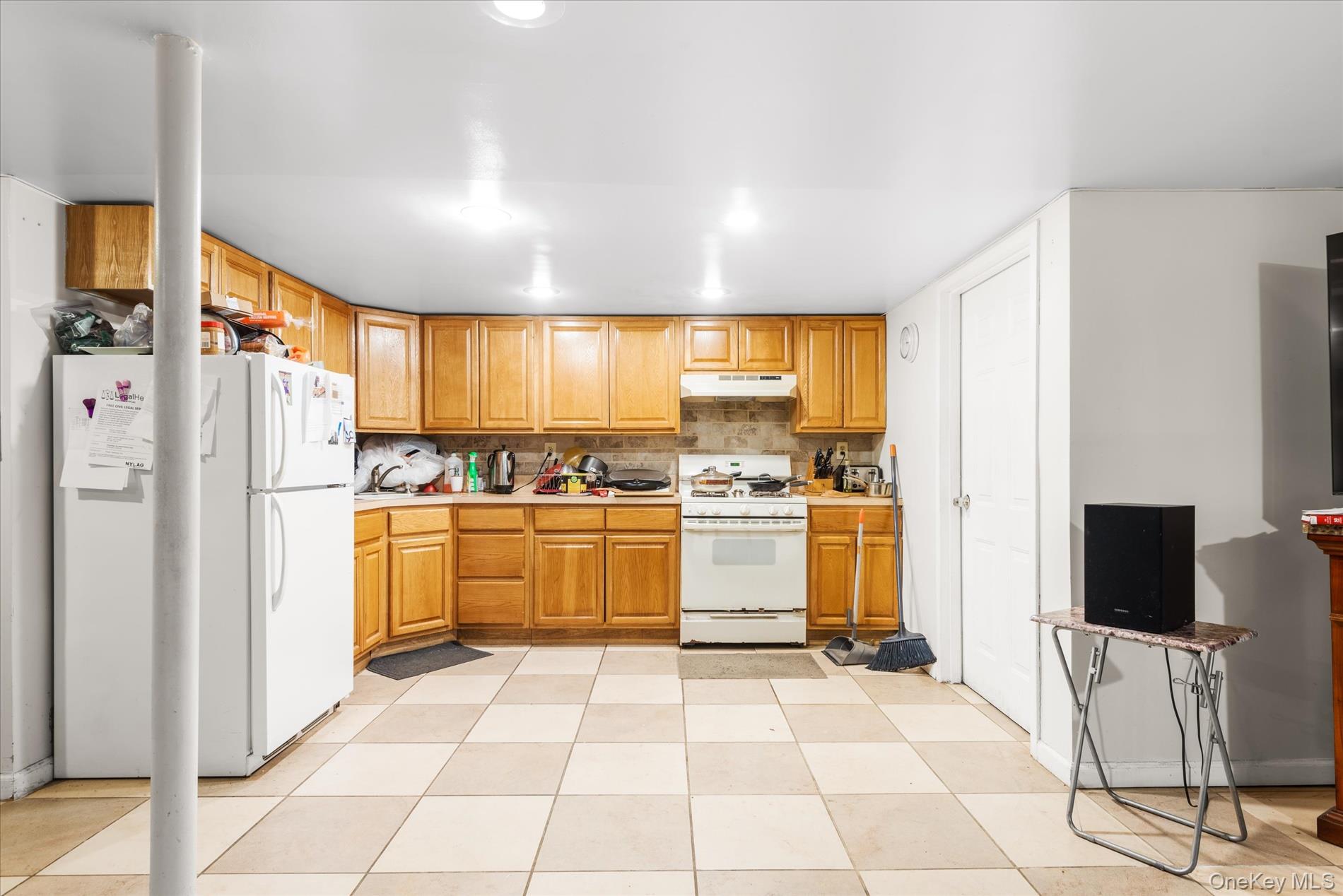 151-42 82nd Street Queens, NY 11414 - Photo 14 of 24 a kitchen with a refrigerator and cabinets