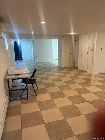 a view of a room with a table and chairs in it