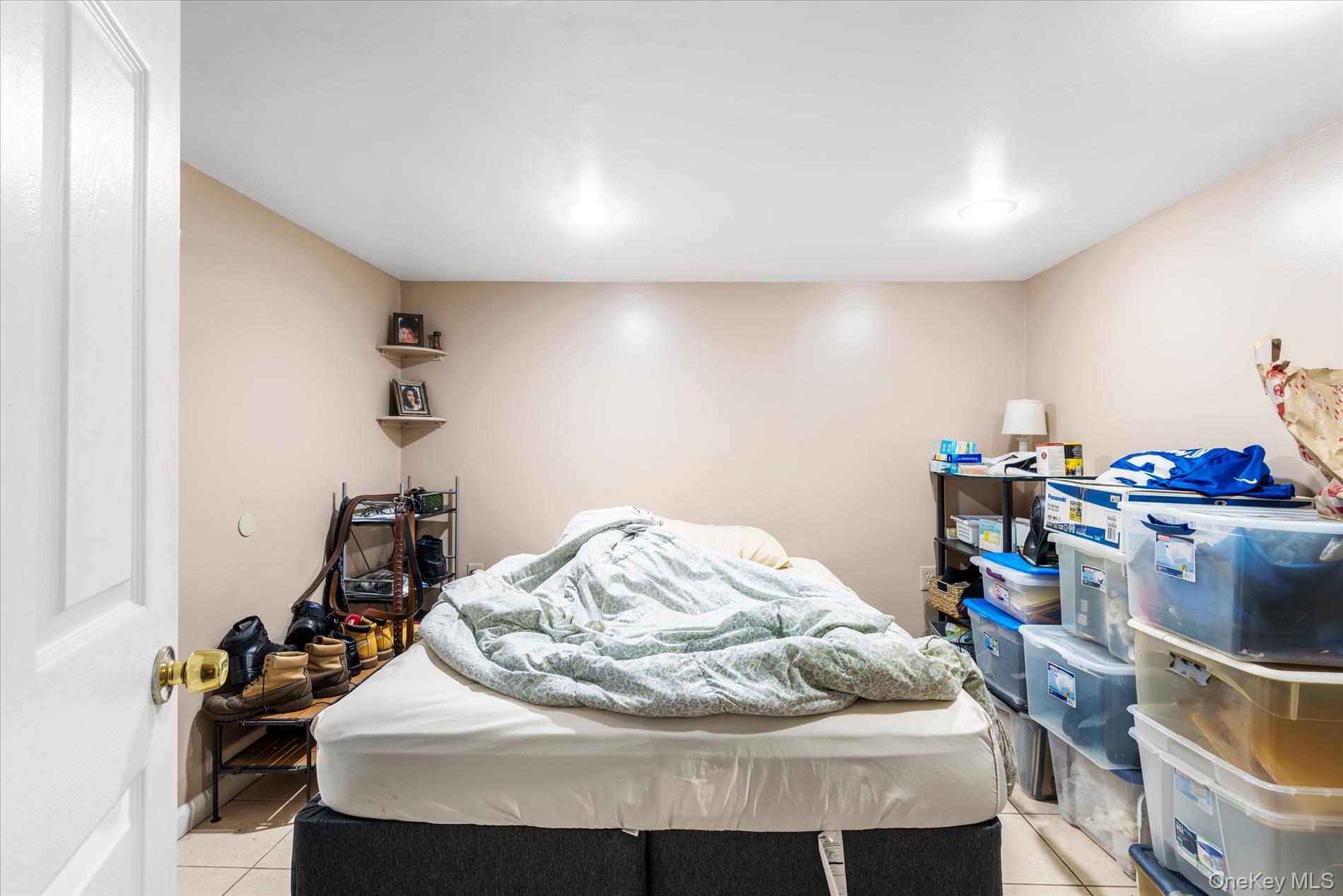 151-42 82nd Street Queens, NY 11414 - Photo 16 of 24 a bedroom with a bed and a chandelier