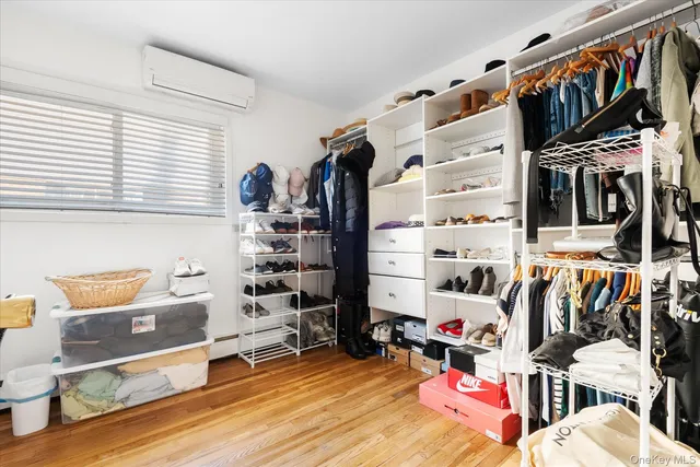 a view of walk in closet with clothes and shoes