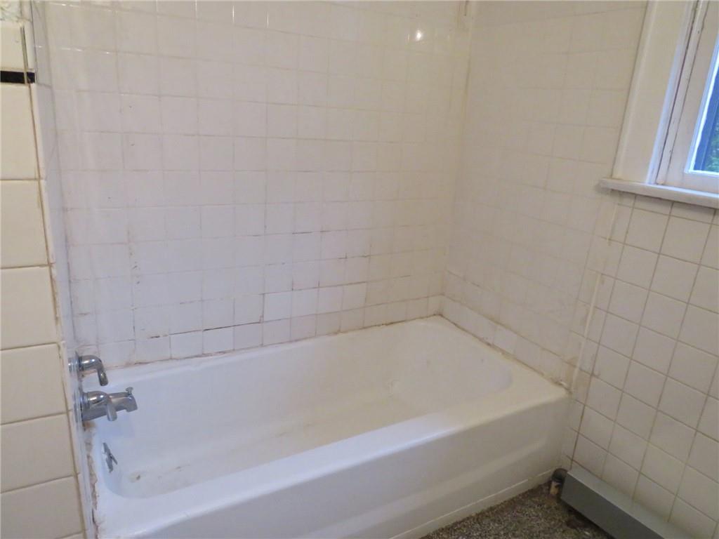 423 Braddock Road Pittsburgh, PA 15221 - Photo 27 of 36 a close up of a bathtub in a bathroom