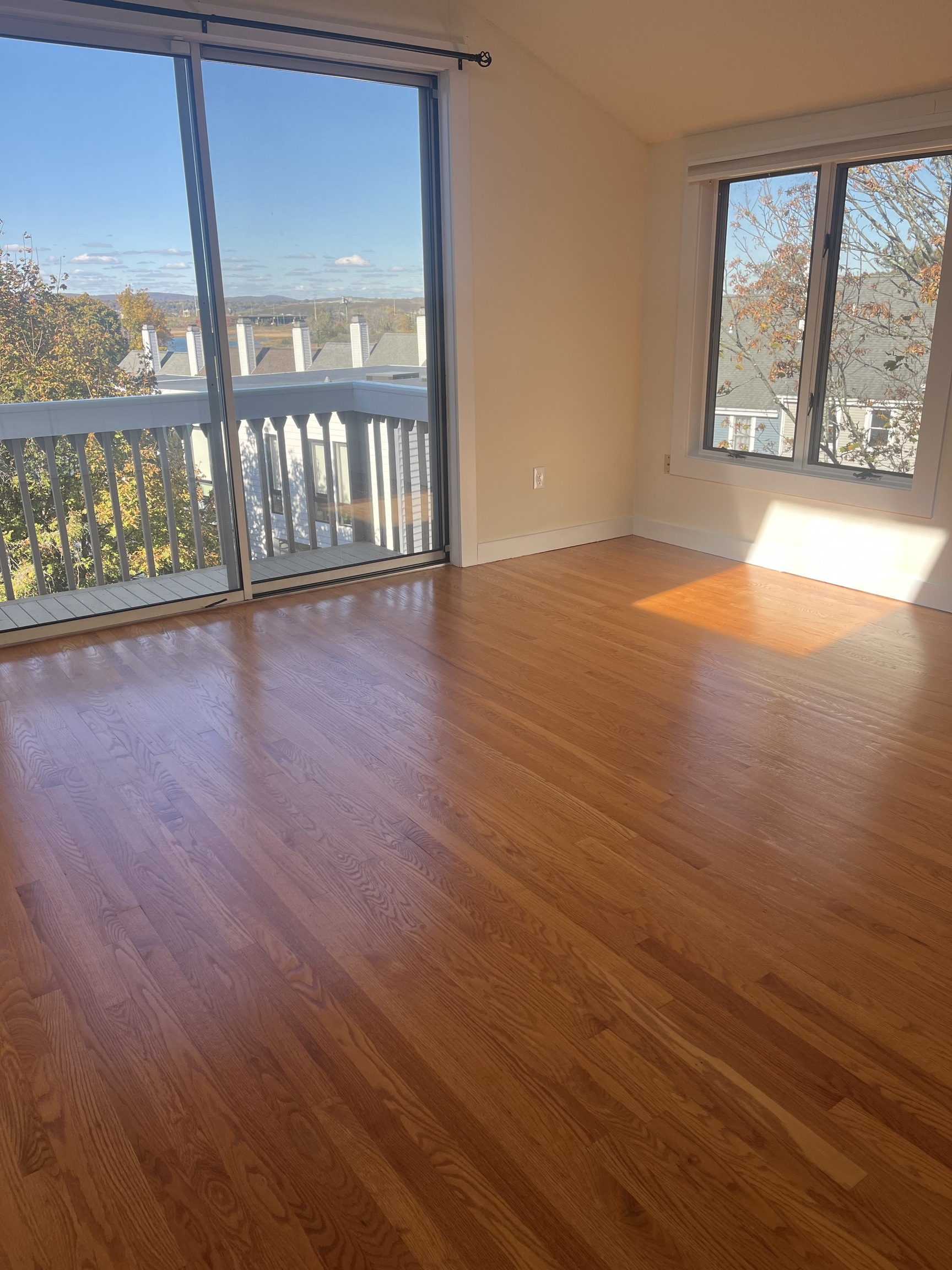 896 Quinnipiac Avenue, Unit 3 New Haven, CT 06513 - Photo 14 of 38 an empty room with wooden floor and windows