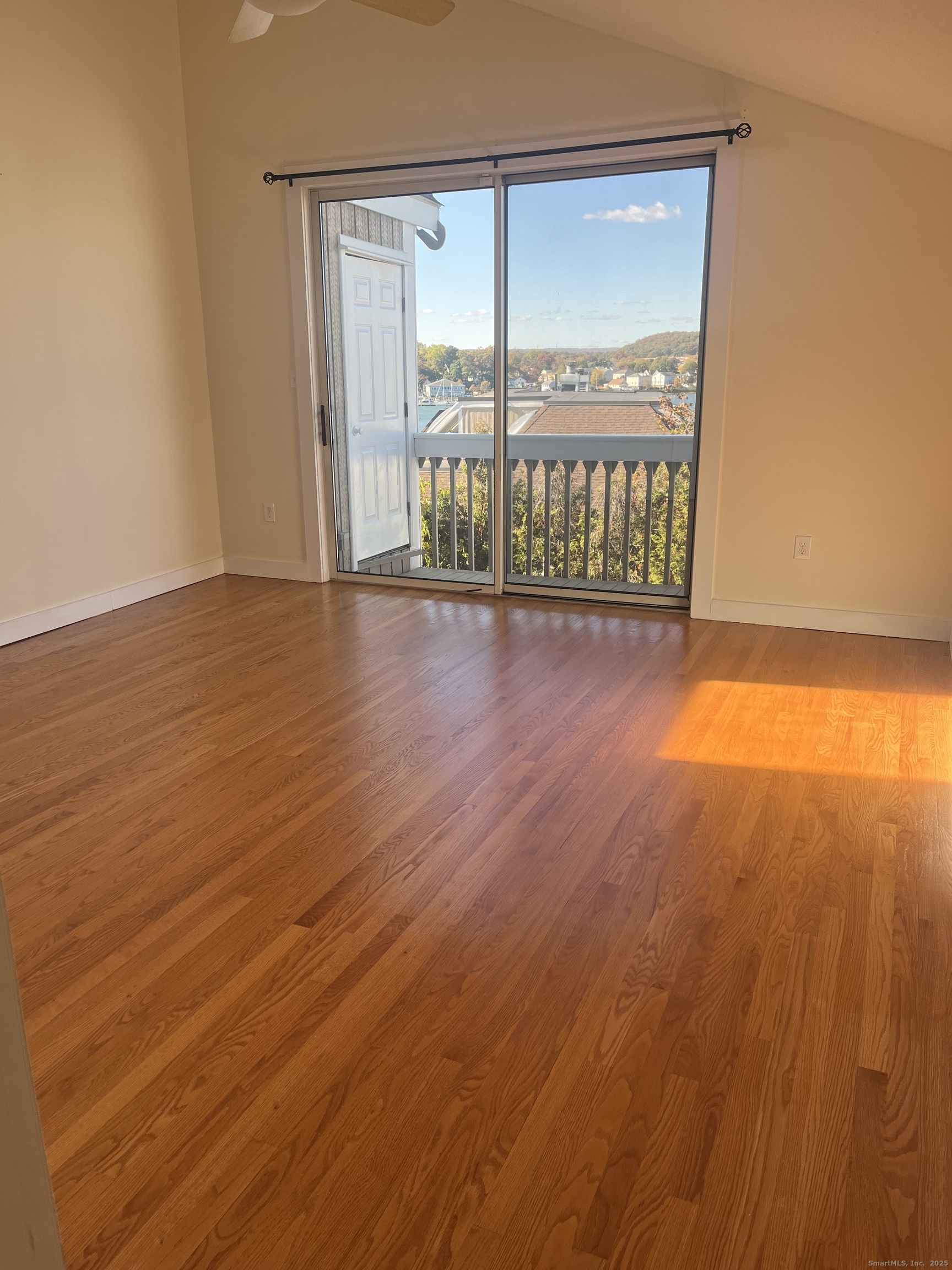 896 Quinnipiac Avenue, Unit 3 New Haven, CT 06513 - Photo 15 of 38 an empty room with wooden floor and windows