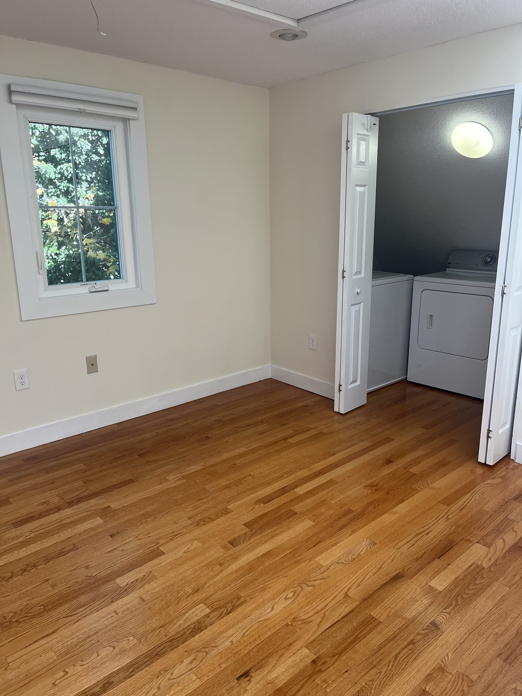 896 Quinnipiac Avenue, Unit 3 New Haven, CT 06513 - Photo 19 of 38 a view of an empty room with wooden floor and a window