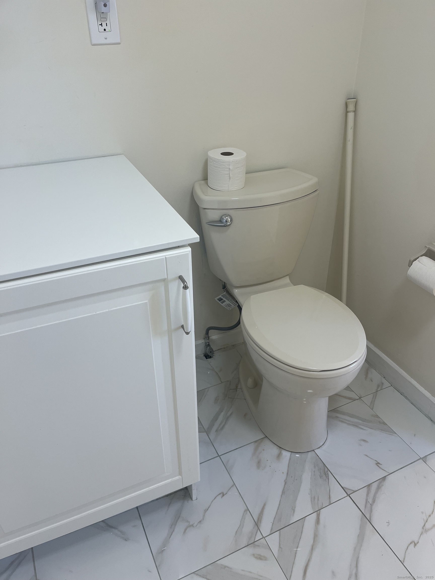 896 Quinnipiac Avenue, Unit 3 New Haven, CT 06513 - Photo 23 of 38 a white toilet sitting next to a white cabinet