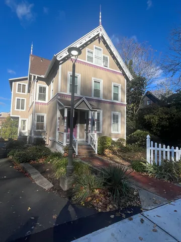 a front view of a house with yard and green space