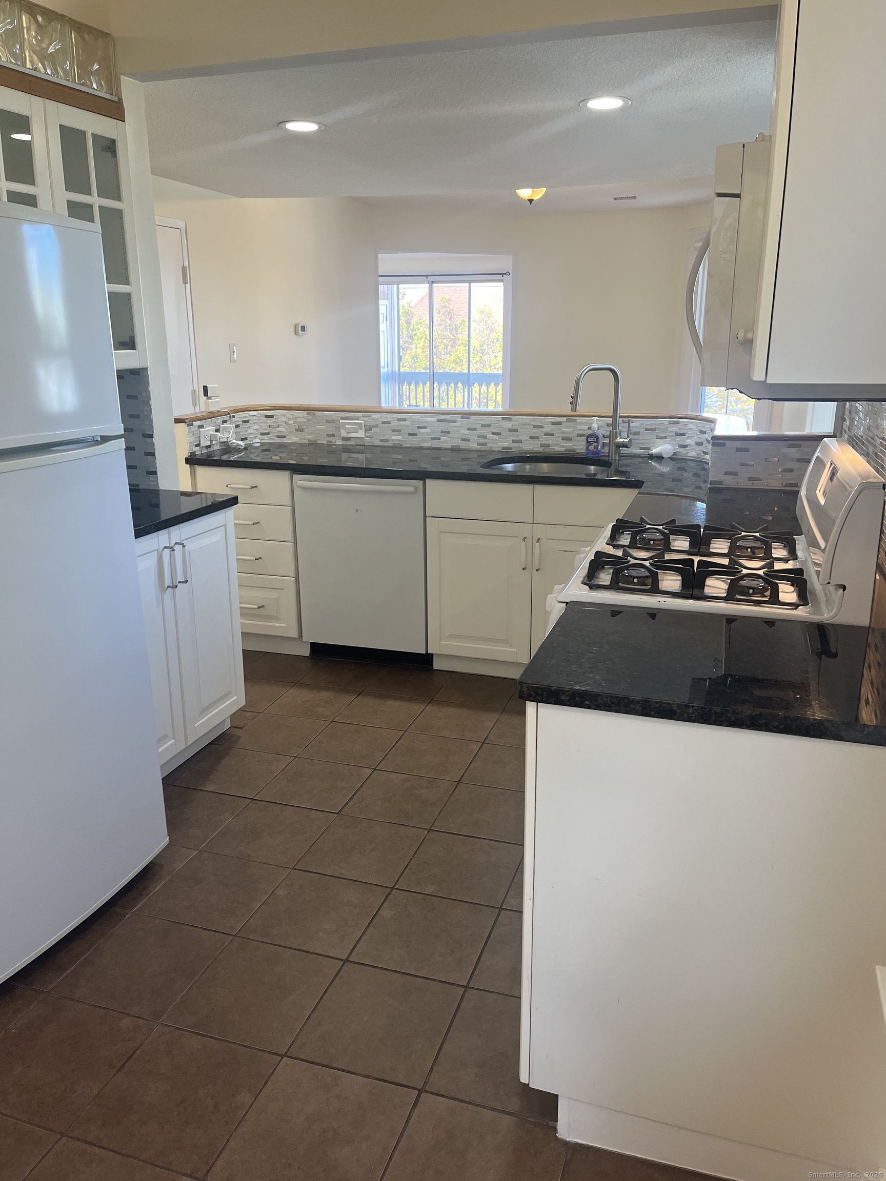 896 Quinnipiac Avenue, Unit 3 New Haven, CT 06513 - Photo 5 of 38 a kitchen with stainless steel appliances granite countertop a sink stove and cabinets